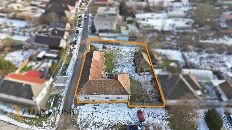 Winter shots of plots - housing in Zemné with a street, houses, and snow-covered roofs.