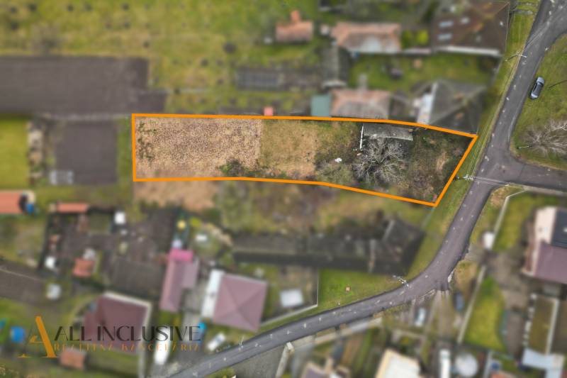 Aerial view of plots - housing in Holice, bordered by an orange line.