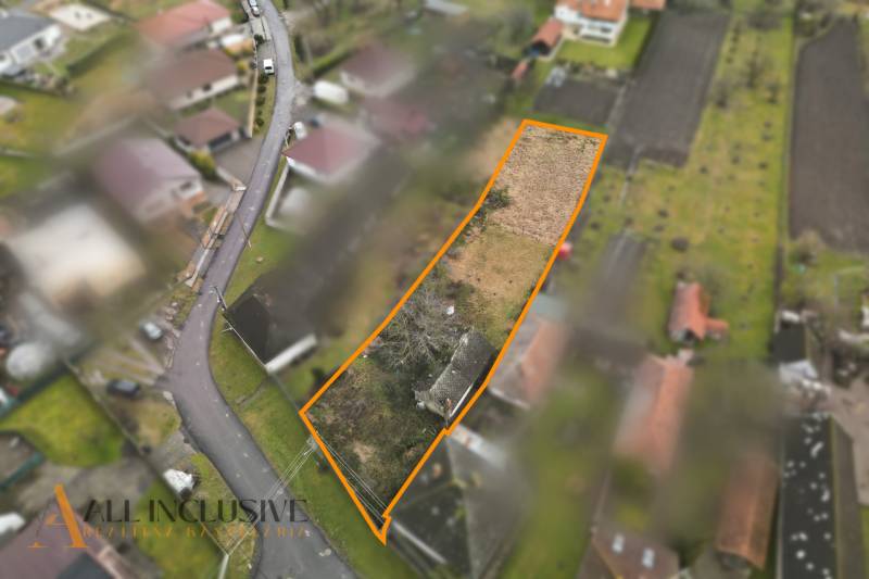 Aerial view of plots - housing in Holice with a garden and a road.