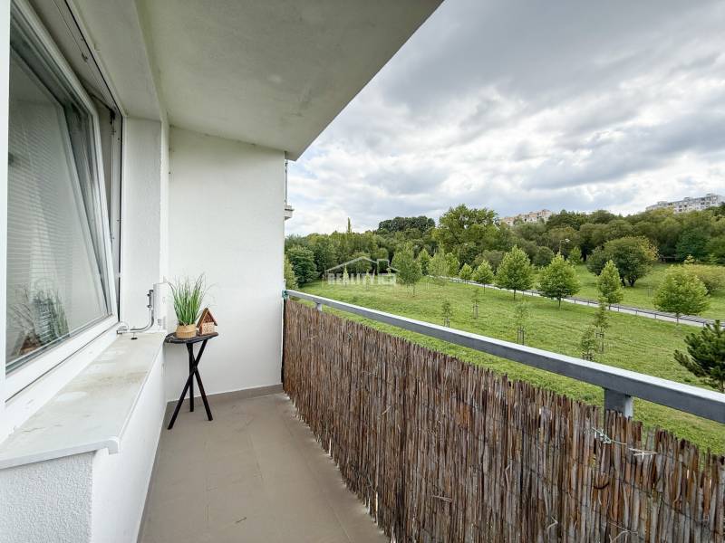 A balcony with a view of greenery in a 2-room apartment on Kvačalova Street in Žilina.