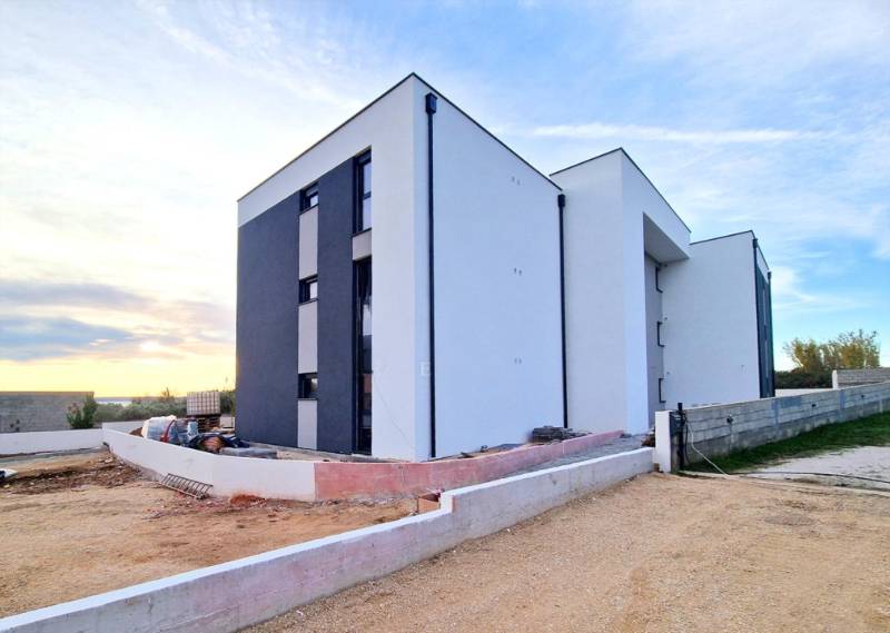 The exterior of a building with 3-room apartments in the Privlaka area in bright daylight.