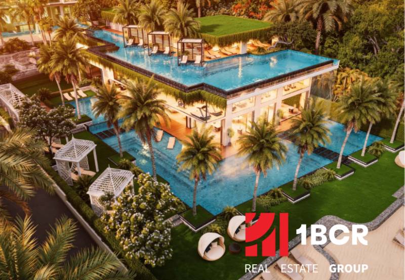 Luxury apartment development in Pattaya with a rooftop pool and tropical greenery.