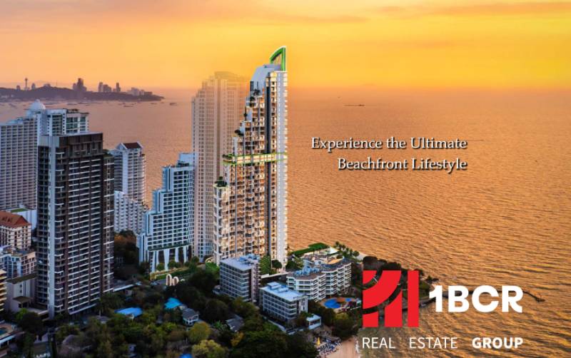 A view of apartment construction in Pattaya with a sea view at sunset.