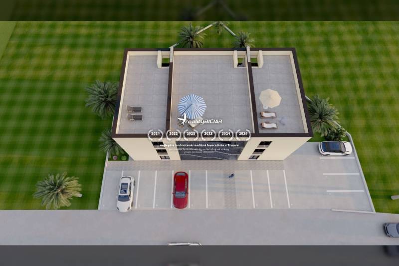 A view from above of a building with a parking lot, rooftop terrace, and surroundings with greenery.