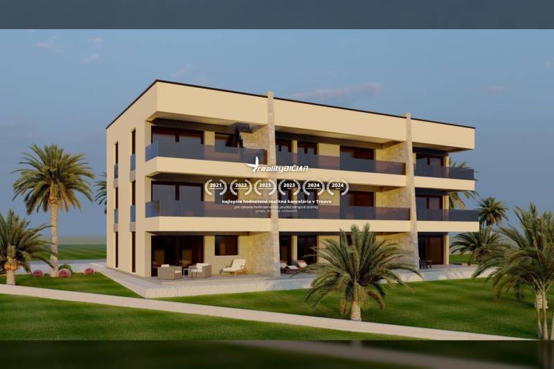 A three-story building in Nin surrounded by greenery and palm trees, overlooking a quiet street.