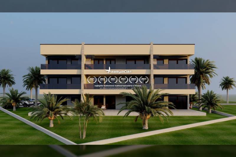 A building with loggias, surrounded by well-maintained greenery and palm trees in the city of Nin.