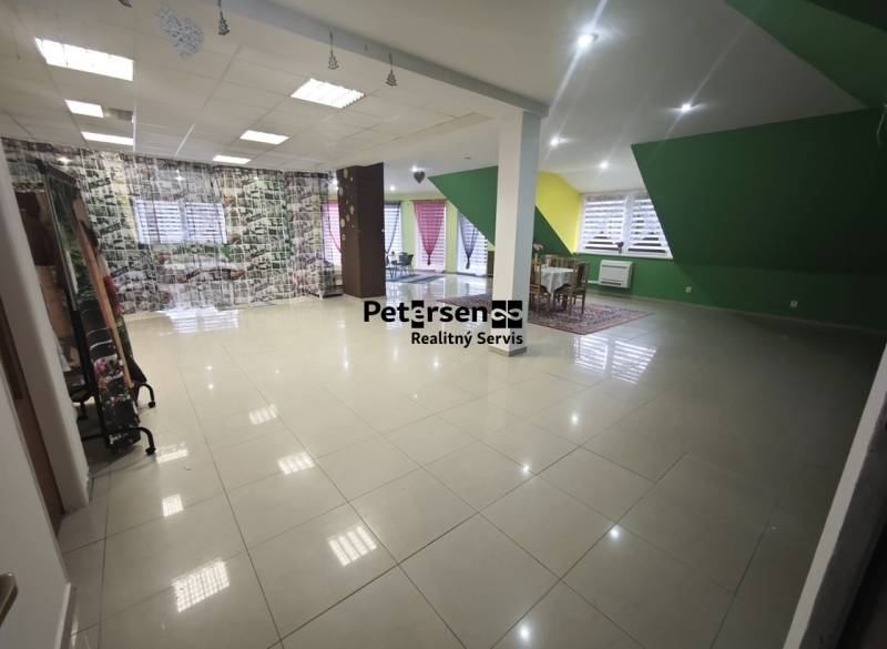 A spacious room in a family house with colorful walls and large windows.