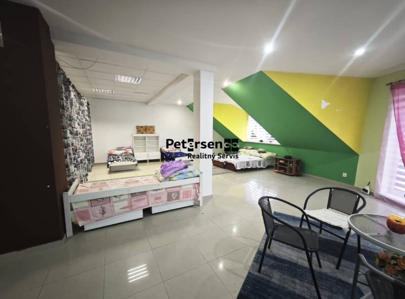 A bedroom in a family house with colorful walls and simple furniture.