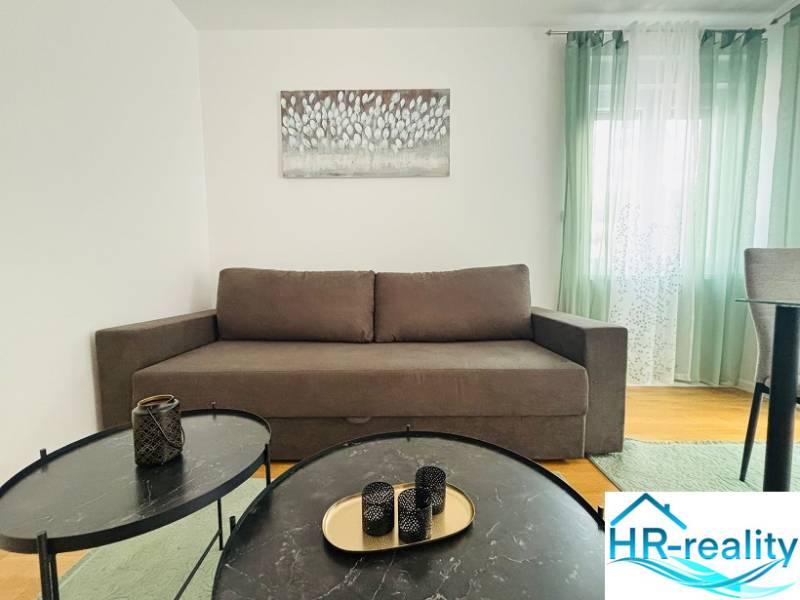 Recreational apartment with a sofa, coffee table, and decorative elements on a floor with a wooden decor.