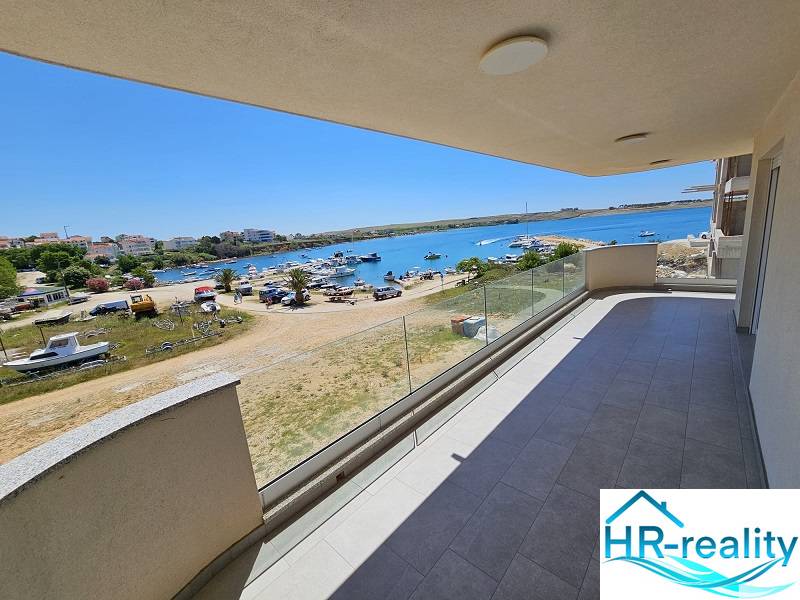 Balcony of a holiday apartment in Povljana with a view of the sea and the beach with boats.