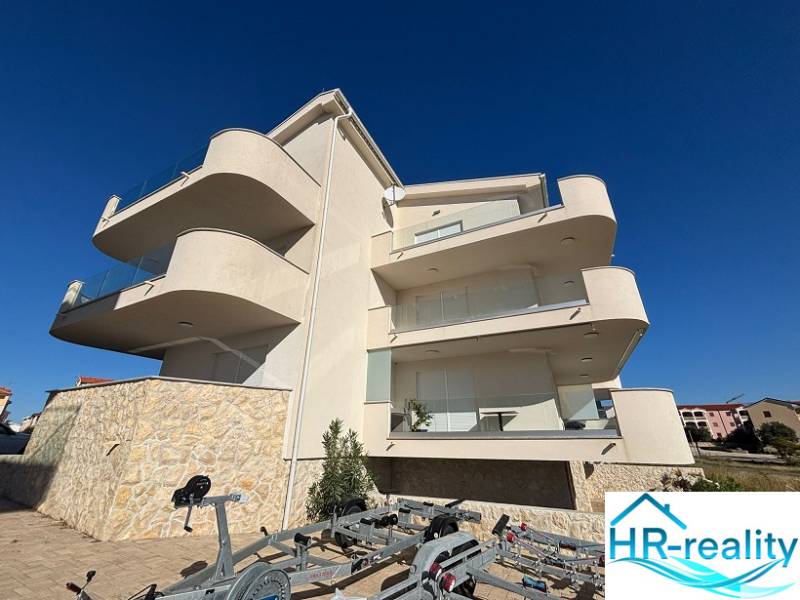 White facade of the Recreational Apartment in Povljana, terraces, and blue sky.