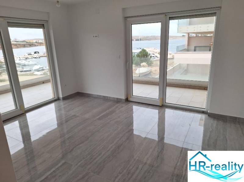 Interior of a holiday apartment with large windows and a view of the harbor.