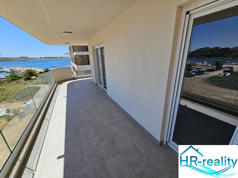 Balcony of a holiday apartment in Povljana with a view of the sea and harbor.