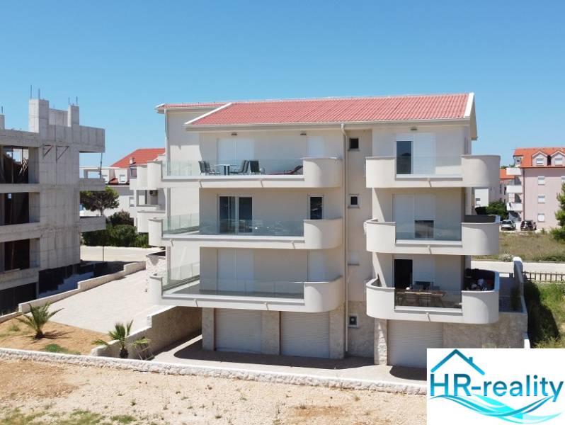 A recreational apartment in Povljana with balconies and a modern facade design.