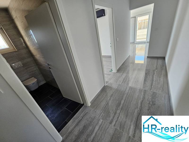 Recreational apartment with a bright hallway, tiles, and light walls.