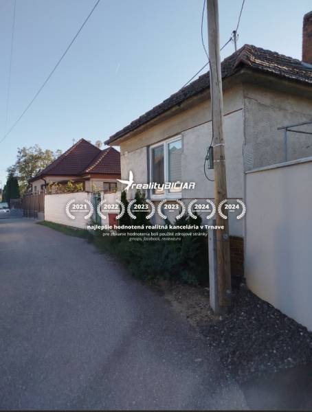 A family house in Siladice with a traditional roof and plaster, along a quiet street.