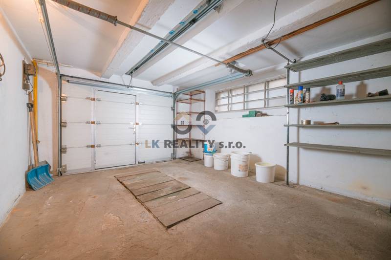 A garage in a family house on Kpt. Jaroš Street in Trenčín with storage shelves.