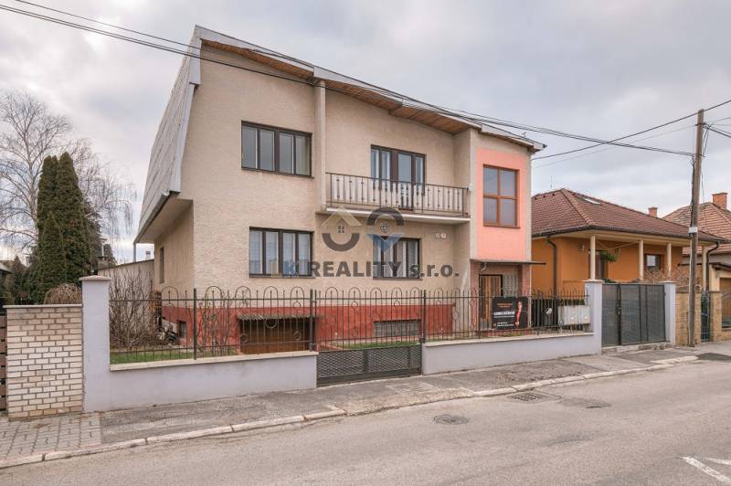 Family house on Kpt. Jaroša Street, Trenčín, with a fenced garden and a balcony.