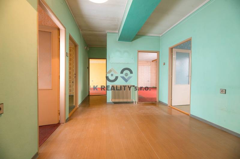 Interior of a family house with green walls and a wooden decor floor.