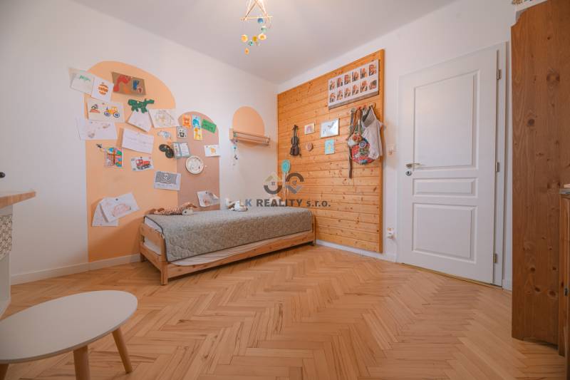 Children's room in a 3-room apartment, wooden wall paneling, floor with wood decor.