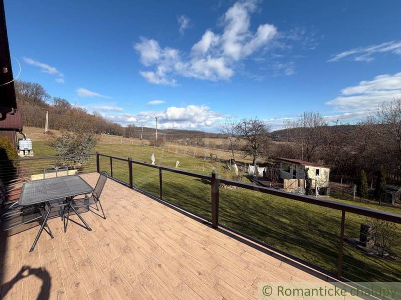The terrace of a family house in Lukovištia with a view of the garden and the countryside.
