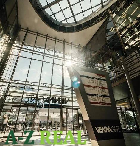 Glass atrium, Vienna Gate on Kopčianska in Bratislava-Petržalka, with an information board.