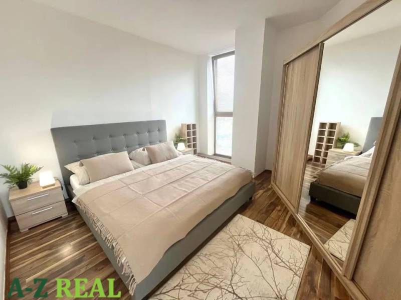 Bedroom in a 3-room apartment, bed, wardrobe with doors, and floor with wooden decor.