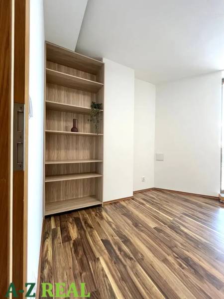 Storage shelf and floor with wood decor in a 3-room apartment.