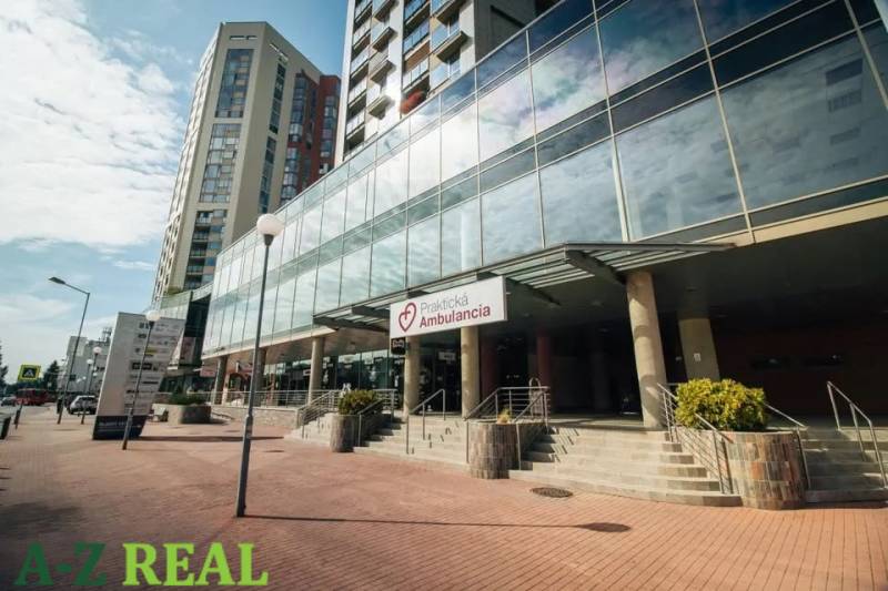 Glass buildings and an ambulance on Kopčianska Street in Bratislava - Petržalka.