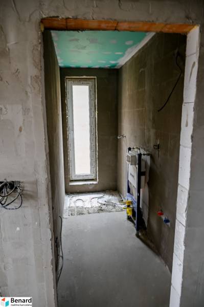 Interior of a 3-room apartment with raw walls and preparation for a sanitary corner.
