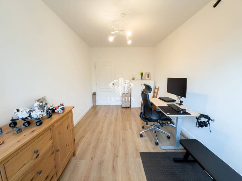 A study in a 4-room apartment with a wood-patterned floor and a computer desk.