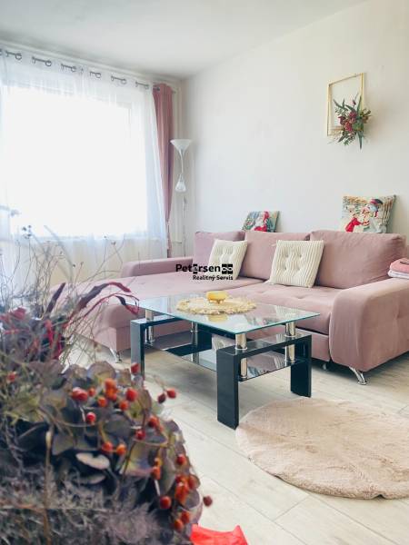 Living room in a 3-room apartment with a corner sofa and a glass table.