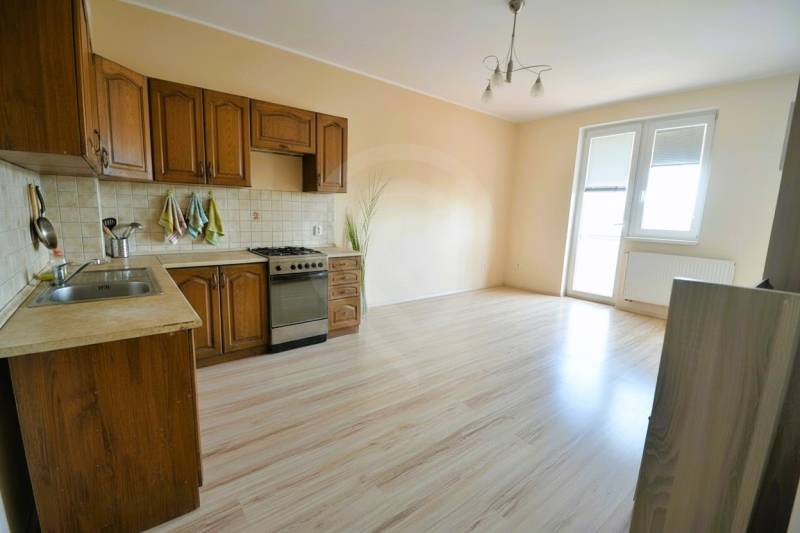 Kitchen in a 2-room apartment with wooden decor and kitchen unit.