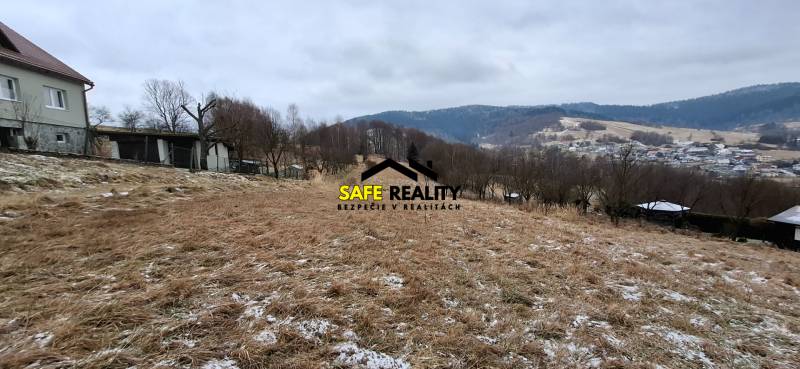 A sloped residential plot in Skalité with a view of the surrounding hills and the village.