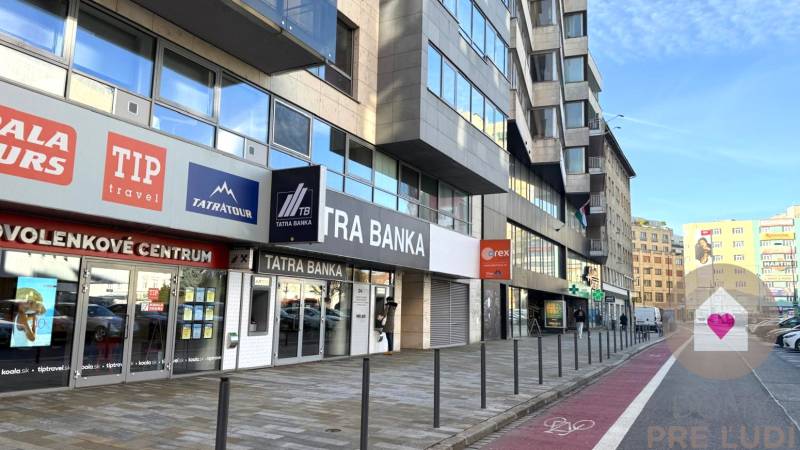 Building on Dunajská Street in Bratislava - Old Town with advertisements and entrances to offices.