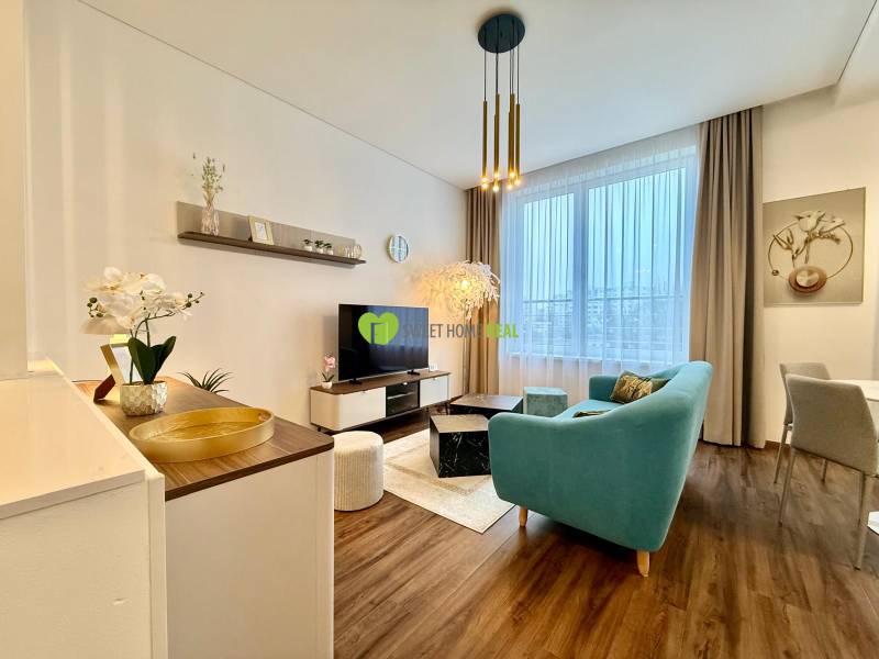 Living room of a two-room apartment with a wooden decor floor and a comfortable sofa.