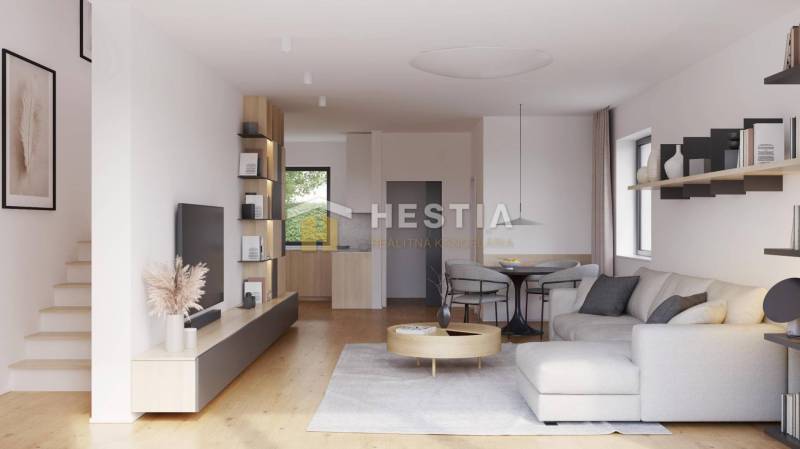 Living room in a family house with a sofa, table, and open kitchen.