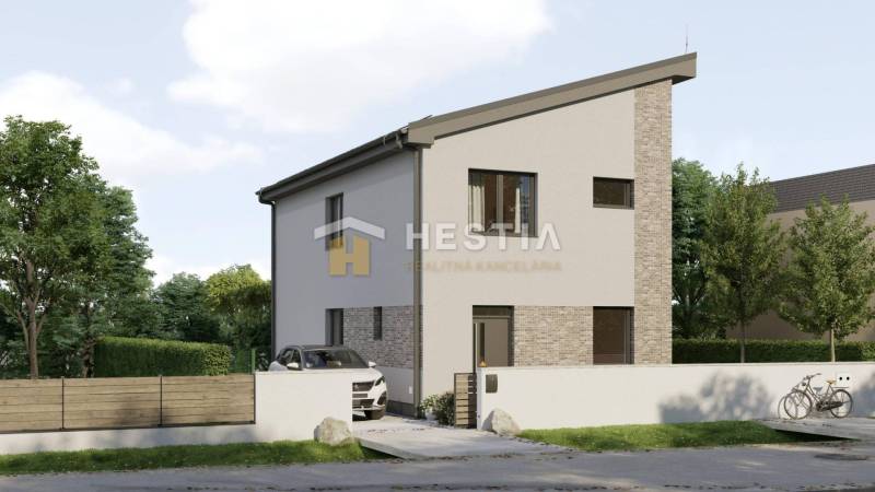 A family house in Cerová with a narrow roof and white facade, surrounded by greenery.