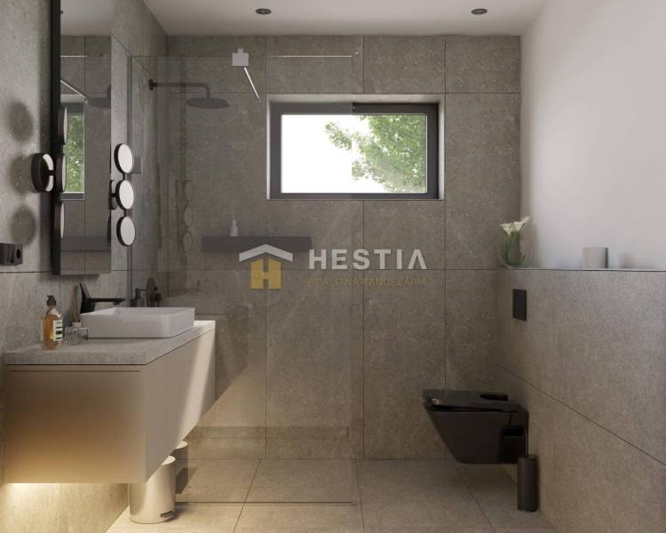 A bathroom in a family house with a modern shower and sink, elegant gray tiles.