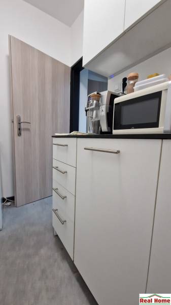 Offices with cabinets, a microwave, and kitchen appliances.