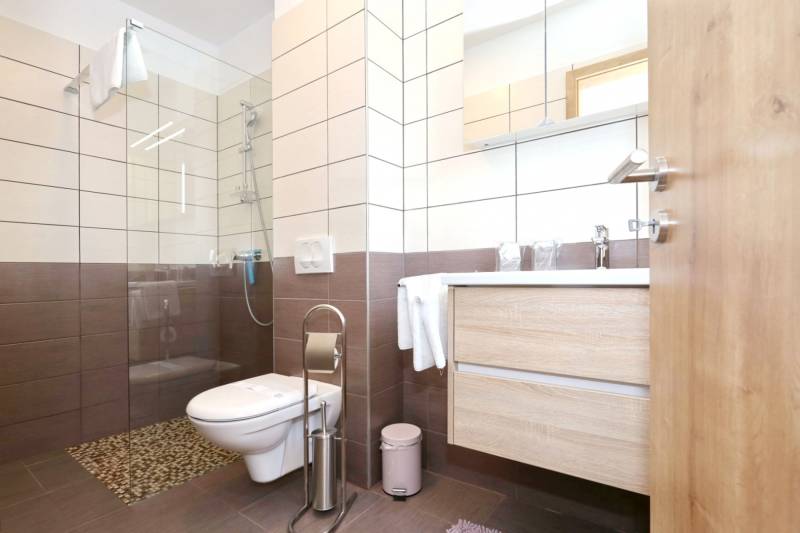 Bathroom with tiles and a shower in a 3-room apartment.