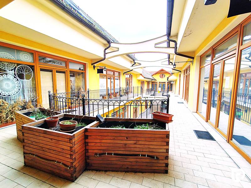 Shop windows on Potočná Street in Skalica with wooden decorations and railings.