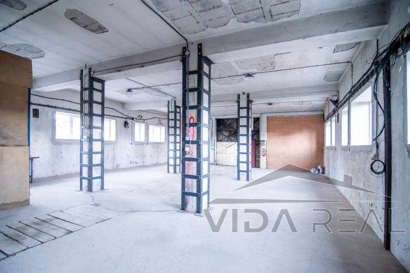 Industrial interior of warehouses and halls with concrete walls and iron beams.