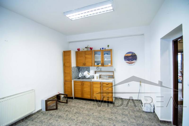 The interior of the warehouse with halls includes a kitchen unit, decorations, and a tiled floor.