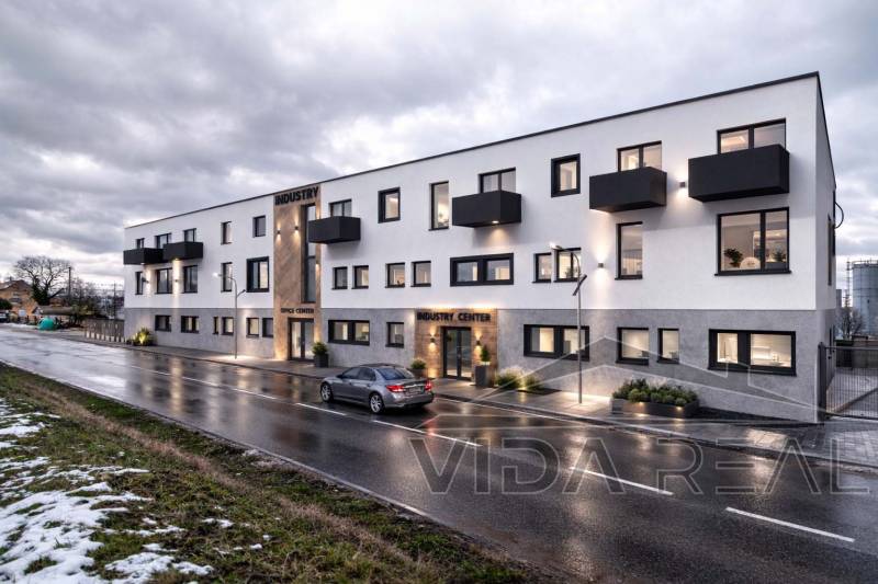 The building on Nádražná Street in Šenkvice, Warehouses and Halls, with evening lighting.