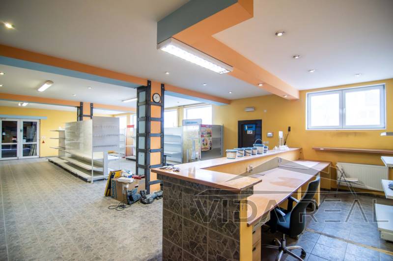 Interiors of warehouses and halls with entrance reception, shelves, and lighting.