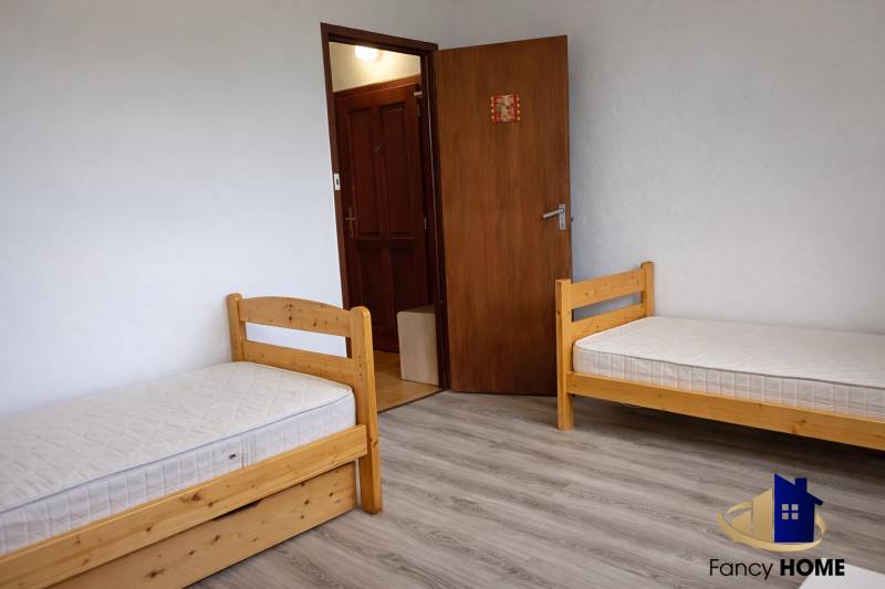 Children's room with standard beds and a floor with wood decor in a 3-room apartment.