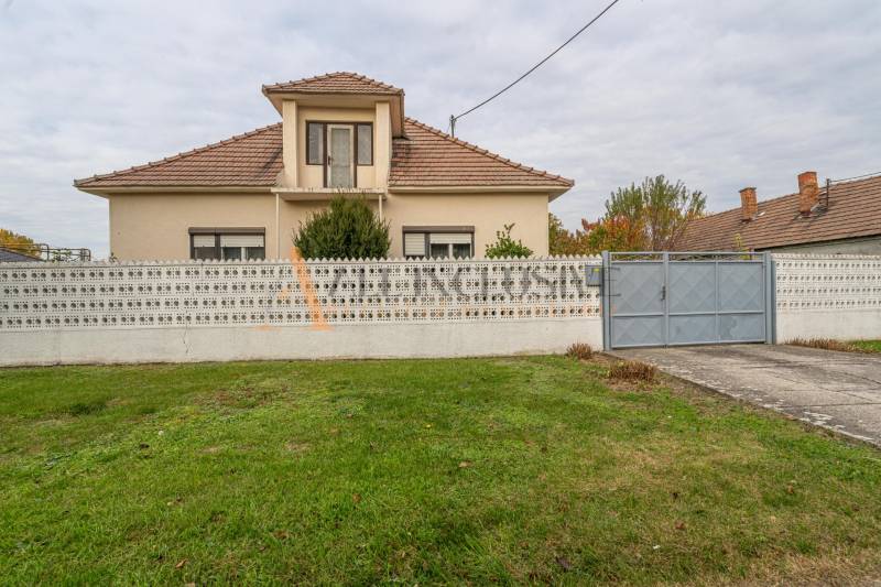 A family house in Veľké Dvorníky with a fence and a well-maintained garden.