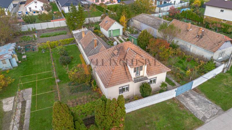 A family house in Veľké Dvorníky with a spacious garden, garage, and cultivation areas.