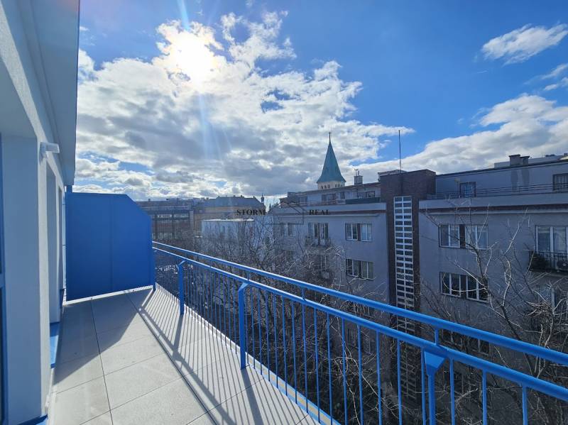 A sunny balcony with a view of the rooftops of buildings in Bratislava - Old Town, Poštová.